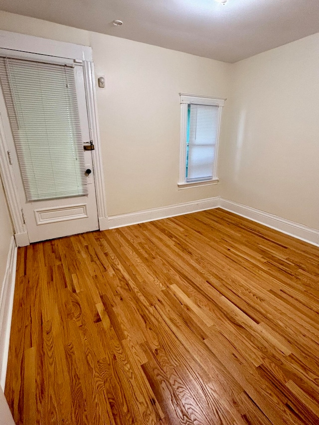 empty room with hardwood / wood-style flooring