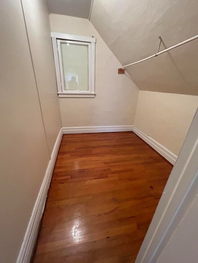 bonus room featuring dark hardwood / wood-style flooring and lofted ceiling