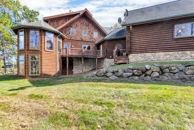 back of house featuring a deck and a yard