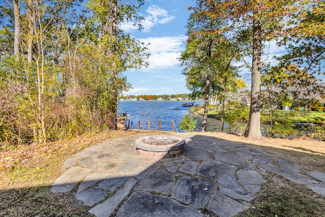 view of patio featuring an outdoor fire pit and a water view