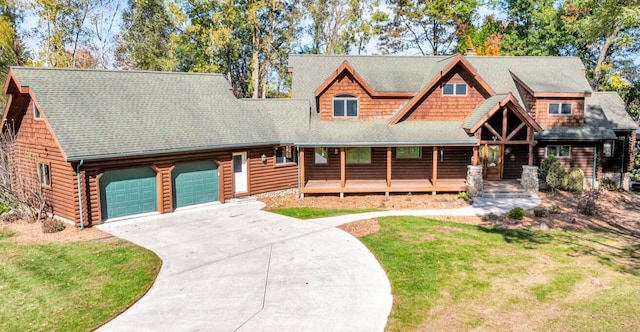 log-style house with a front yard, covered porch, and a garage