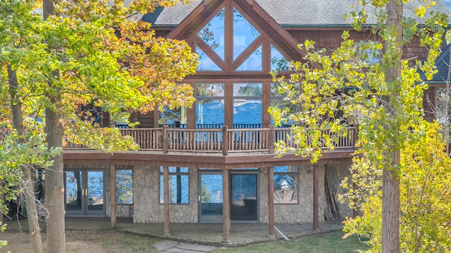 rear view of property featuring a deck and a patio area