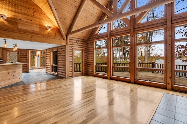 interior space featuring lofted ceiling with beams and wooden ceiling