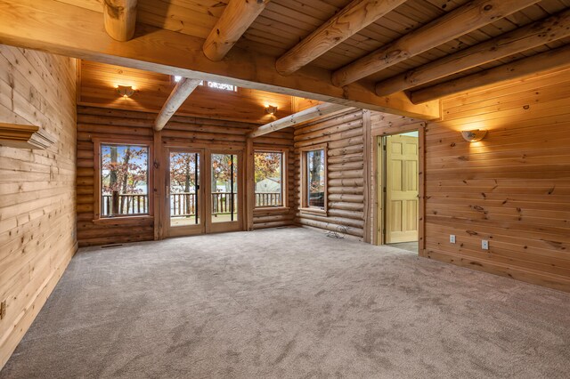 unfurnished living room featuring a healthy amount of sunlight and carpet floors