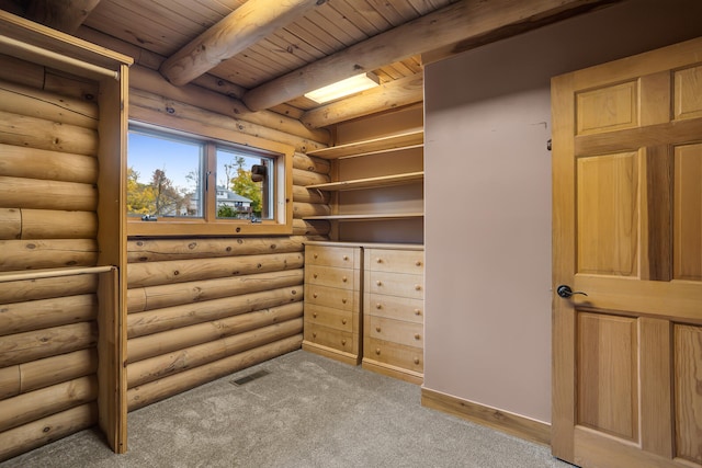 spacious closet featuring beamed ceiling and light carpet