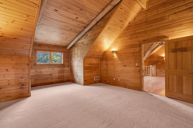 additional living space with carpet floors, wood walls, and wood ceiling