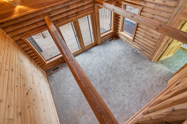 unfurnished living room featuring light carpet and lofted ceiling with skylight