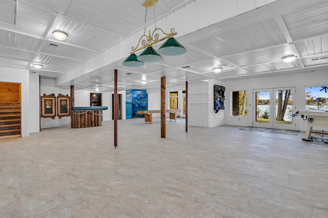 basement featuring french doors and indoor bar