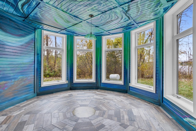 unfurnished sunroom featuring a wealth of natural light