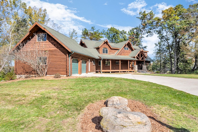 log cabin with a front lawn and a garage