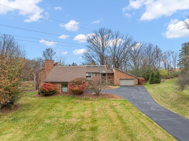 view of front of home featuring a garage and a front yard