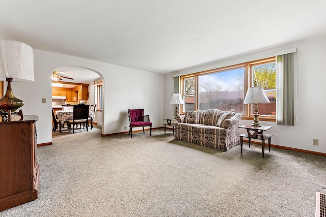 living room featuring carpet and ceiling fan