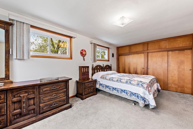 bedroom featuring wooden walls and light colored carpet