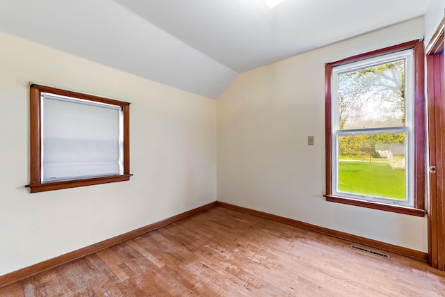 bonus room with light hardwood / wood-style flooring and lofted ceiling