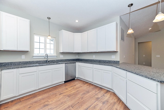 kitchen with white cabinets, sink, decorative light fixtures, and dishwasher