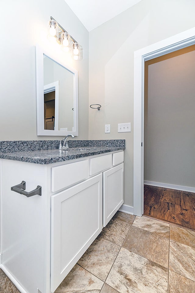 bathroom with vanity and hardwood / wood-style flooring