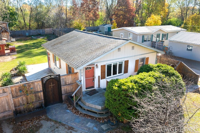 view of front of home with a front yard and a deck