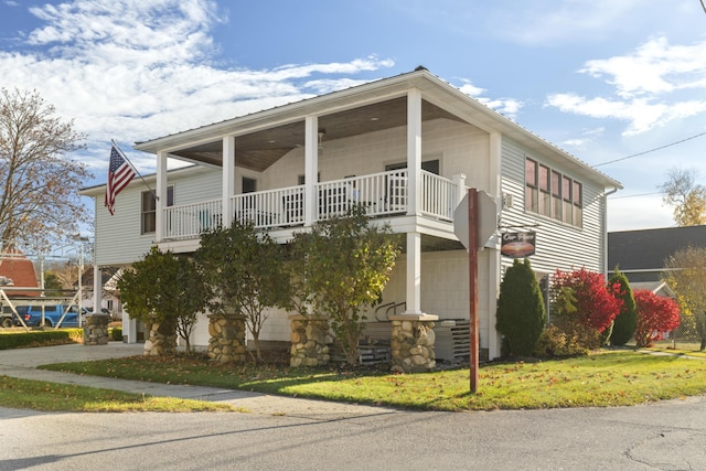 87 S Center St, Beulah, MI 49617 - view of home's exterior featuring a balcony and a carport