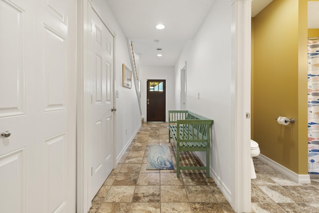 87 S Center St, Beulah, MI 49617 - hall featuring stone tile flooring, baseboards, and recessed lighting