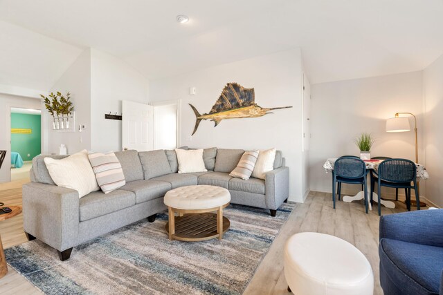 87 S Center St, Beulah, MI 49617 - living room featuring wood finished floors, vaulted ceiling, and baseboards