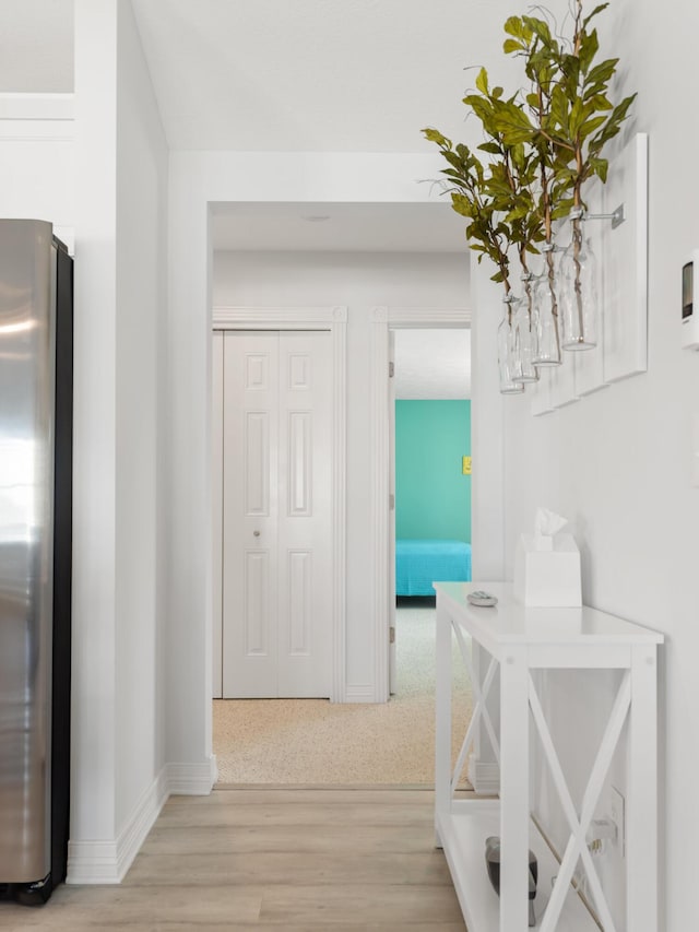 87 S Center St, Beulah, MI 49617 - hallway with light wood-style flooring and baseboards