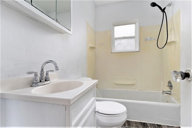 full bathroom with hardwood / wood-style floors, vanity, toilet, and shower / washtub combination