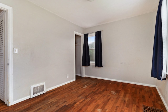 unfurnished room featuring dark wood-type flooring