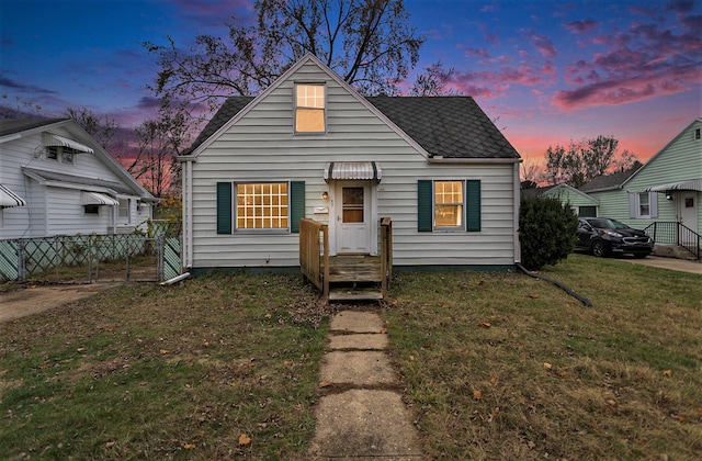 bungalow-style home with a yard