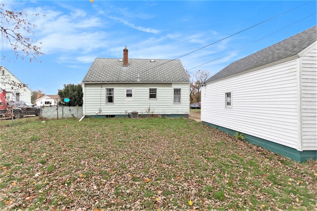 back of house with a lawn