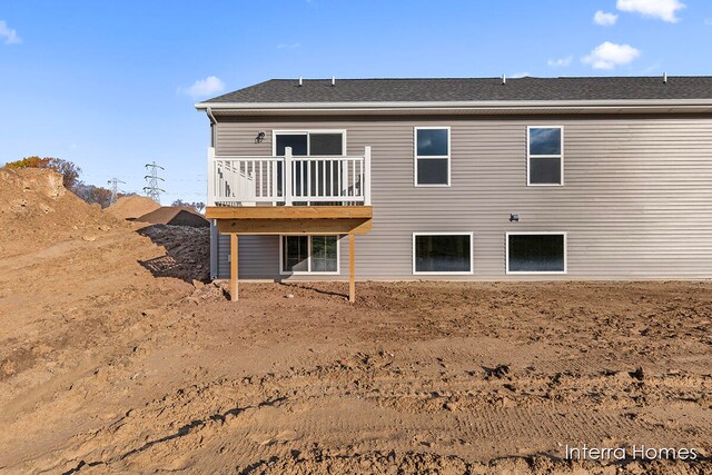 back of house featuring a wooden deck