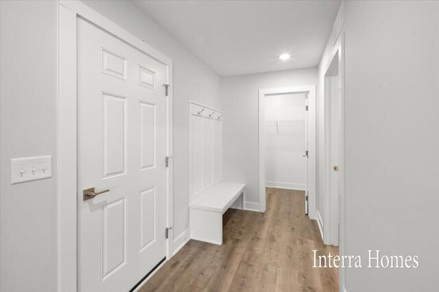 mudroom with wood finished floors and baseboards