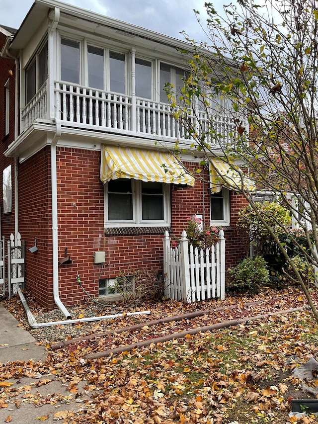 view of side of home featuring a balcony