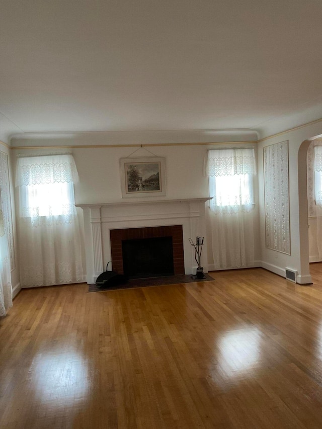 unfurnished living room featuring light hardwood / wood-style floors and a fireplace