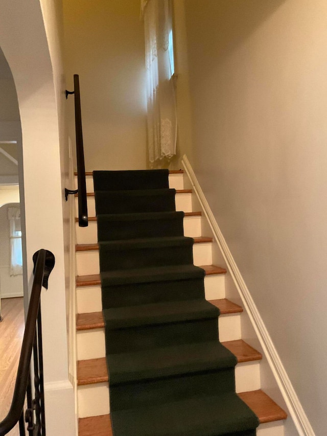 stairs with hardwood / wood-style floors