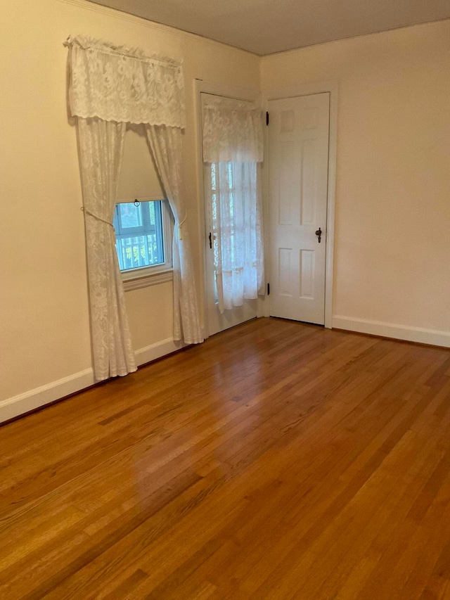 unfurnished room featuring hardwood / wood-style flooring