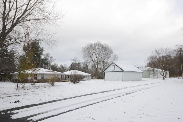 snowy yard featuring an outdoor structure