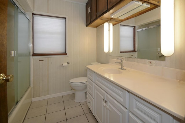 full bathroom with tile patterned flooring, vanity, toilet, and enclosed tub / shower combo