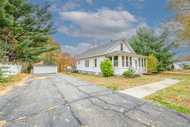 1820 River Bluff Rd, Niles, MI 49120 - view of front of house with an outbuilding, a detached garage, roof with shingles, and fence