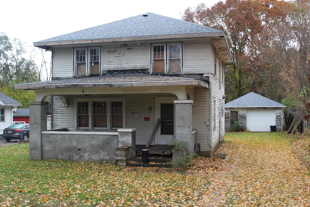 view of front property with a porch, an outbuilding, and a garage