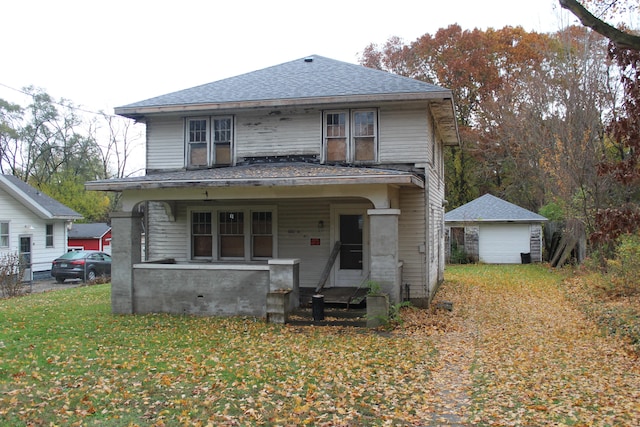 view of front of property with covered porch, a storage shed, and a front lawn