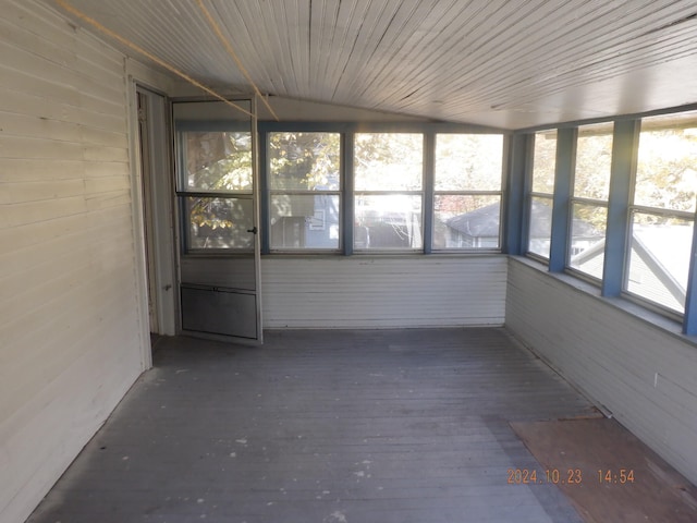 unfurnished sunroom with lofted ceiling