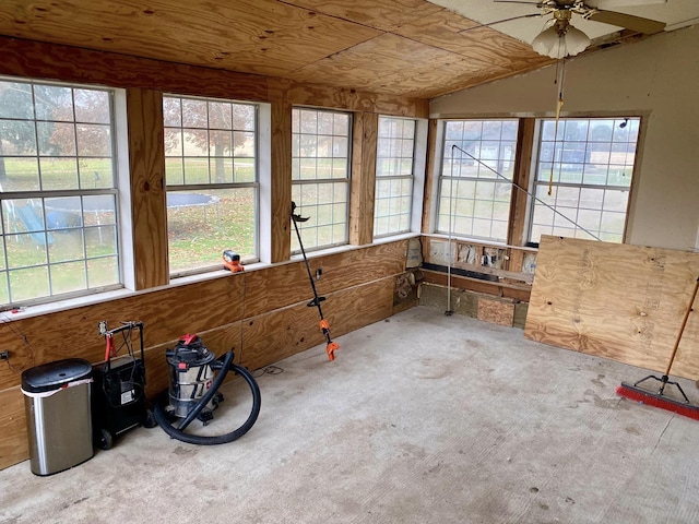 unfurnished sunroom featuring plenty of natural light, lofted ceiling, ceiling fan, and wood ceiling