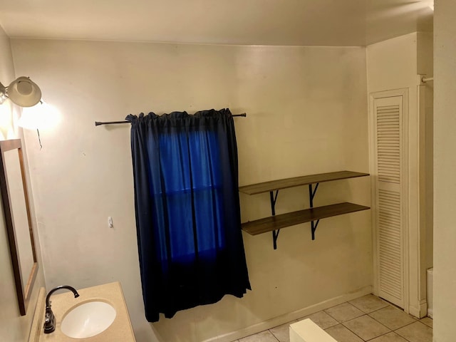 bathroom featuring tile patterned flooring and vanity