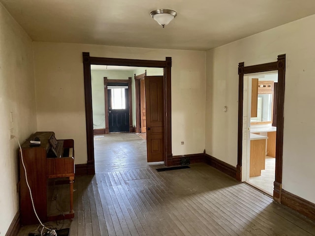 spare room featuring wood-type flooring