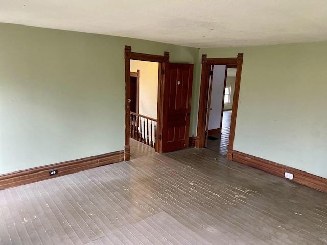 unfurnished room with wood-type flooring