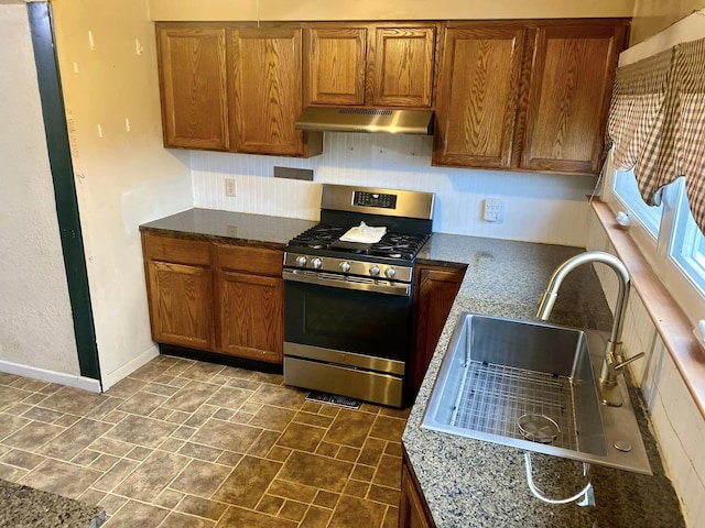 kitchen with stainless steel gas range oven and sink