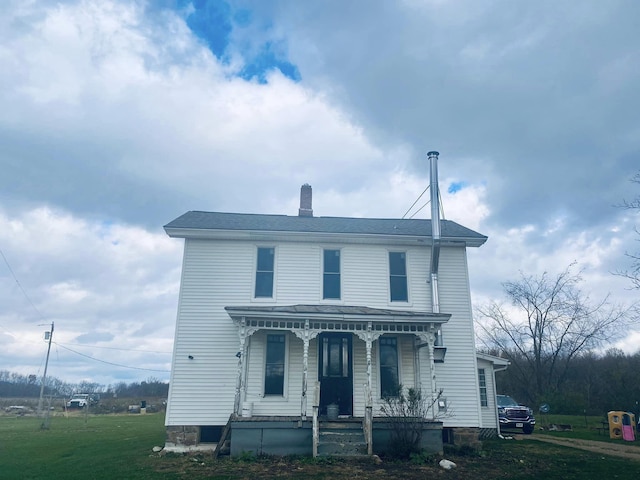 view of front facade with a porch and a front lawn