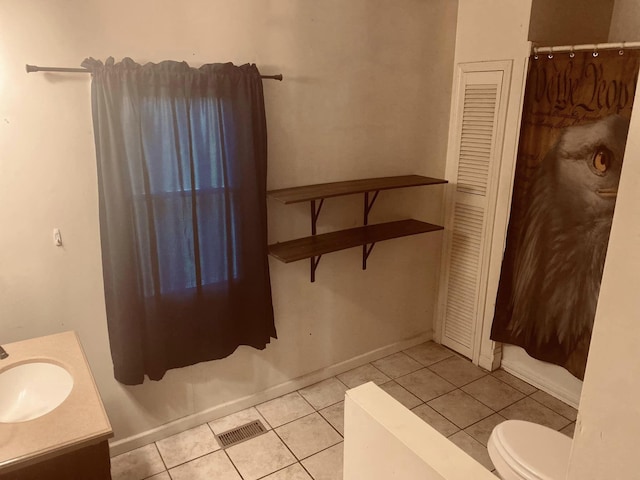 bathroom featuring vanity, tile patterned flooring, and toilet