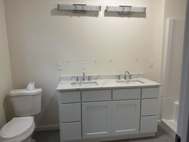 bathroom featuring toilet and vanity