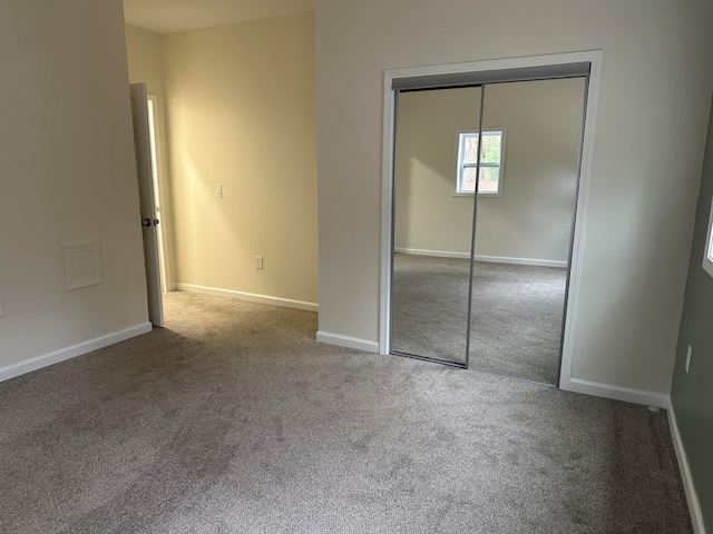 unfurnished bedroom with carpet flooring and a closet